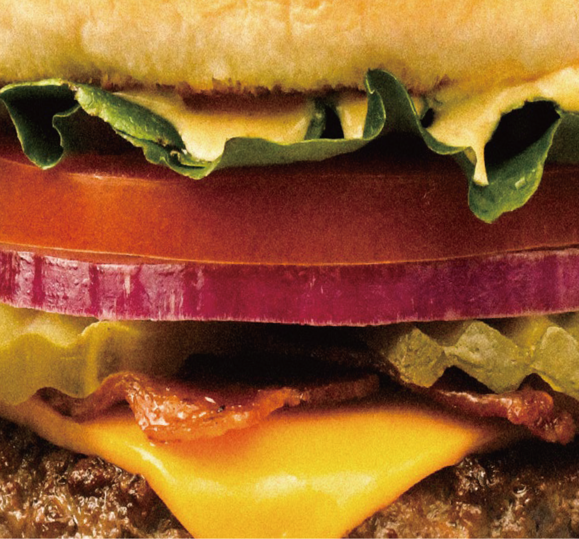 Close-up of an Onestar burger with cheese and vegetables